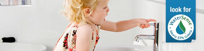 Child using a bathroom faucet.